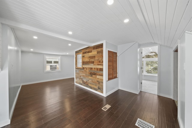 interior space with dark wood-type flooring, a wealth of natural light, and vaulted ceiling with beams