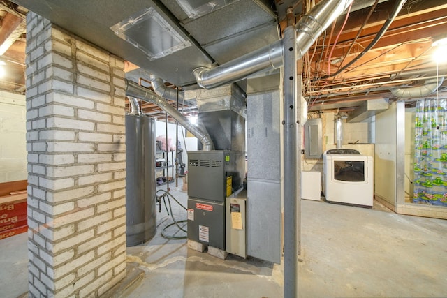 utility room with washer / dryer, heating unit, electric panel, and gas water heater