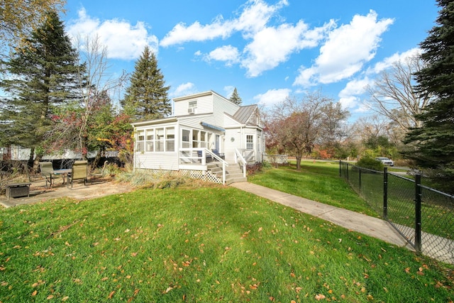 view of front of home featuring a sunroom and a front yard