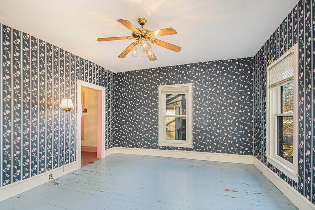 empty room with ceiling fan and wood-type flooring