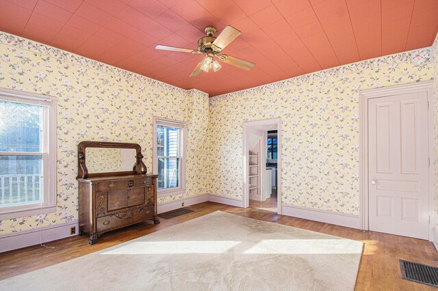 unfurnished bedroom featuring hardwood / wood-style floors and ceiling fan