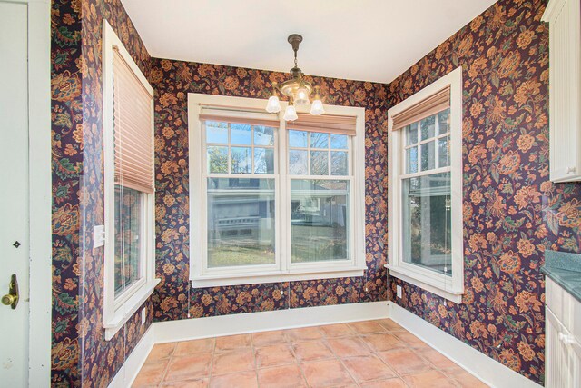 interior space with an inviting chandelier and light tile patterned floors