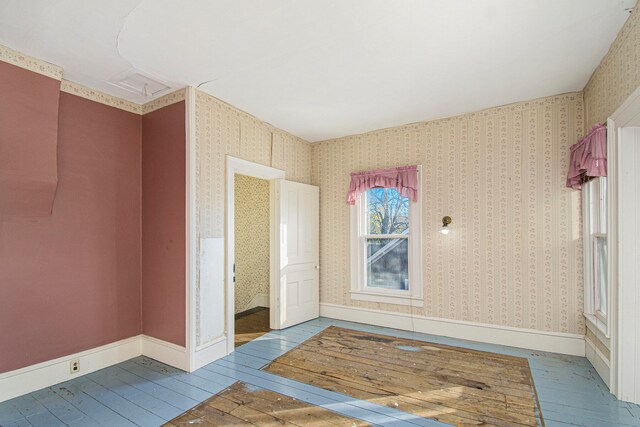 spare room featuring wood-type flooring