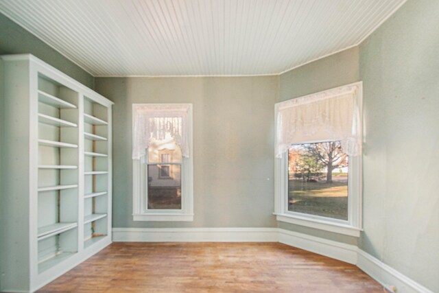 interior space with built in features and hardwood / wood-style floors