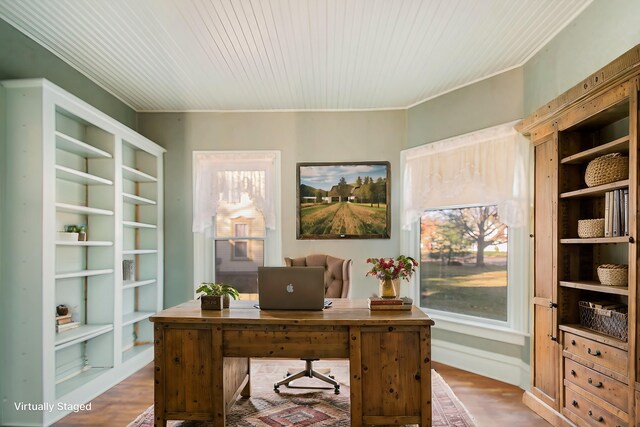 home office featuring built in features and wood-type flooring