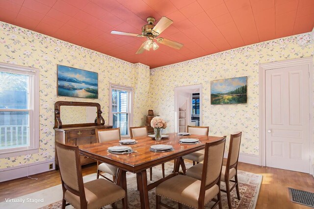 dining room with ceiling fan and hardwood / wood-style flooring