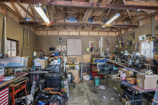 miscellaneous room with concrete floors and a workshop area