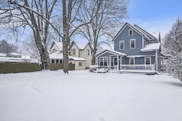 view of snow covered rear of property