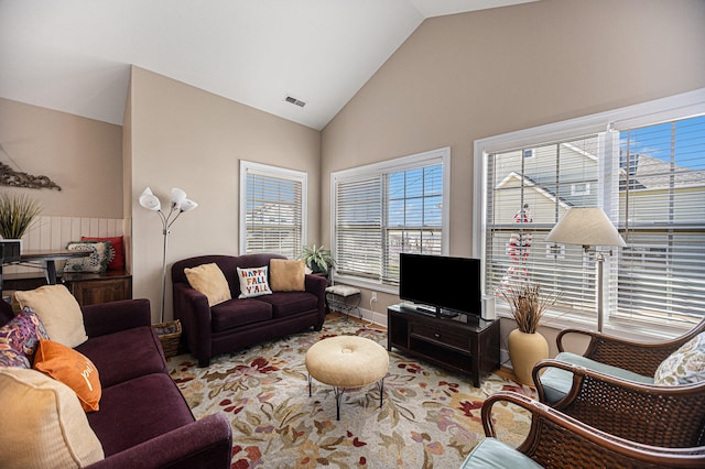 living room featuring high vaulted ceiling