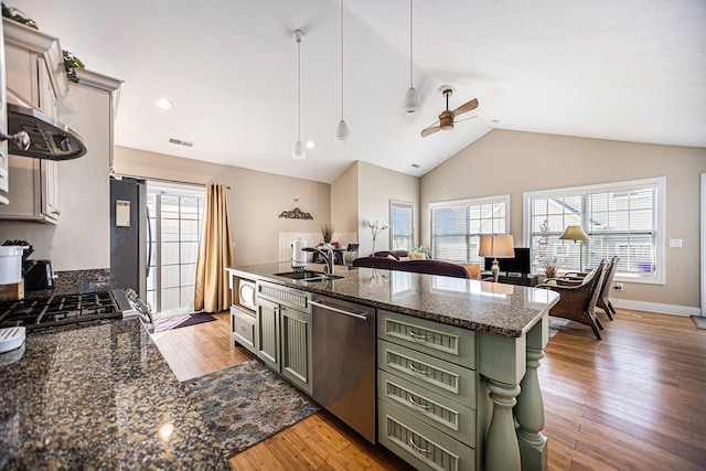 kitchen featuring appliances with stainless steel finishes, decorative light fixtures, green cabinetry, and sink