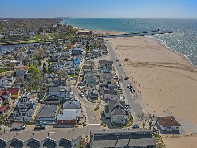 bird's eye view featuring a water view and a beach view