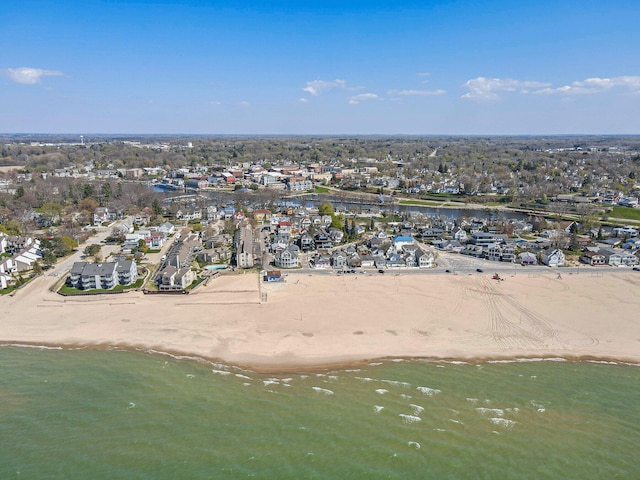 drone / aerial view featuring a water view and a beach view