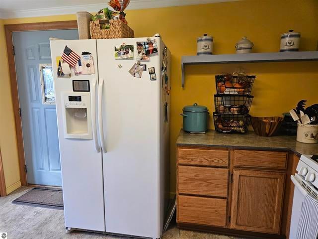 kitchen featuring crown molding and white appliances