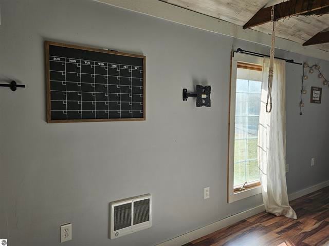 interior space with beamed ceiling and hardwood / wood-style floors