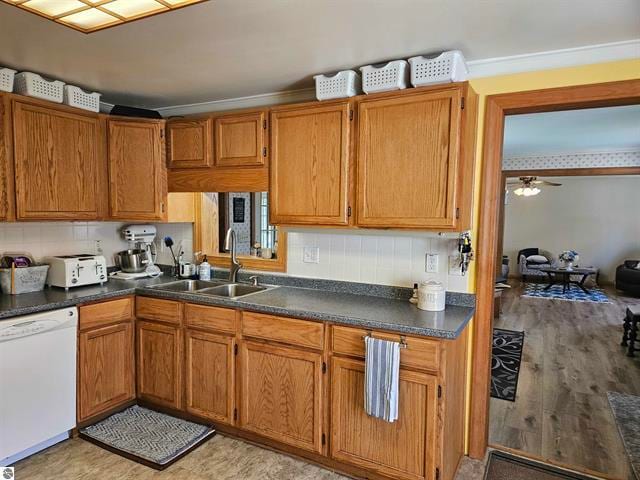 kitchen with ceiling fan, dishwasher, light hardwood / wood-style floors, crown molding, and sink