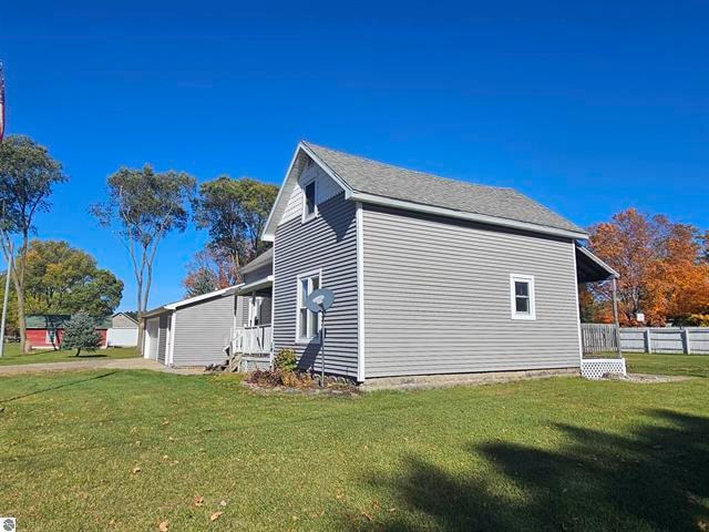 view of side of home featuring a lawn