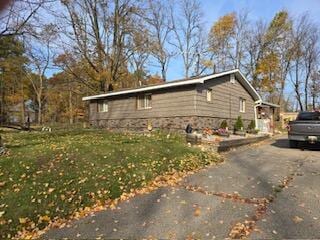 view of side of home with a yard