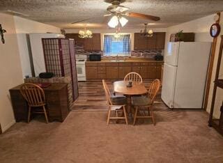 dining space with carpet floors, a textured ceiling, and a notable chandelier