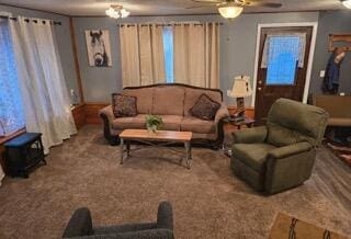 carpeted living room with ceiling fan