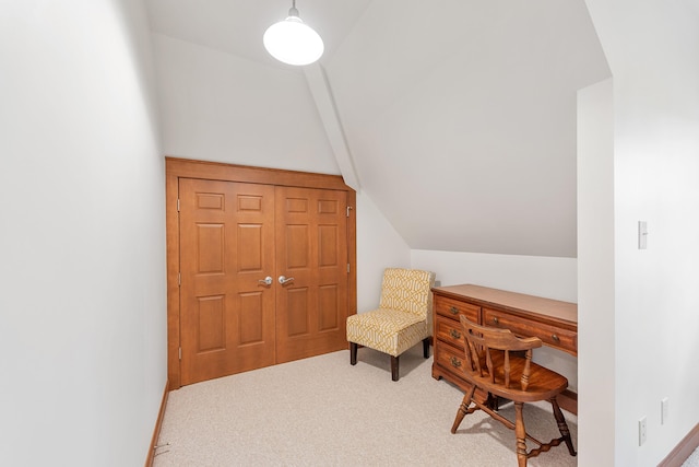 sitting room with carpet flooring and vaulted ceiling