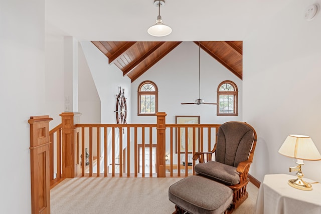 living area with light carpet, a healthy amount of sunlight, wood ceiling, and ceiling fan