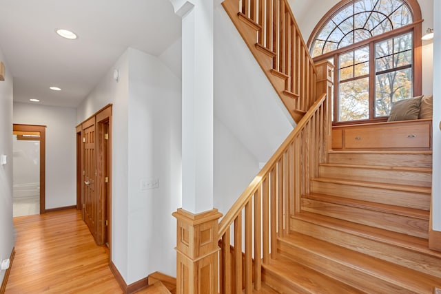 staircase with hardwood / wood-style flooring