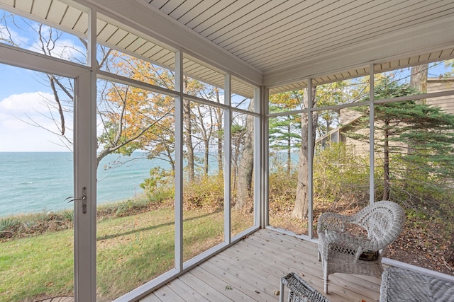 unfurnished sunroom featuring a water view