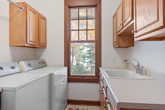 laundry room with a wealth of natural light, sink, separate washer and dryer, and cabinets