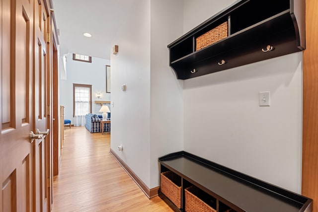 mudroom with light hardwood / wood-style floors