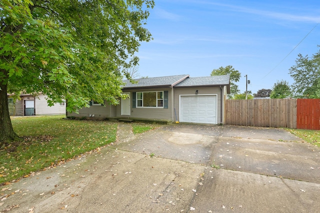 ranch-style home featuring a front lawn and a garage