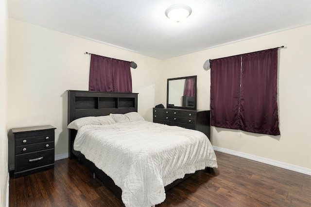 bedroom with dark wood-type flooring