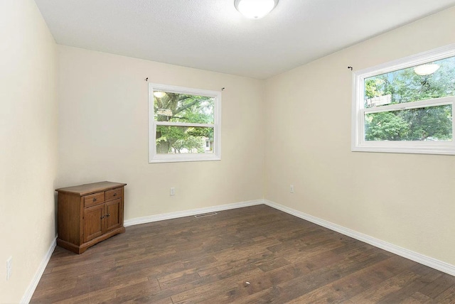 empty room with dark wood-type flooring