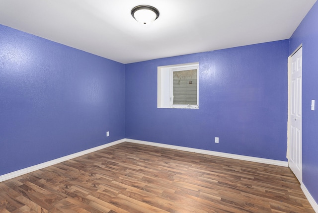 spare room with dark hardwood / wood-style floors