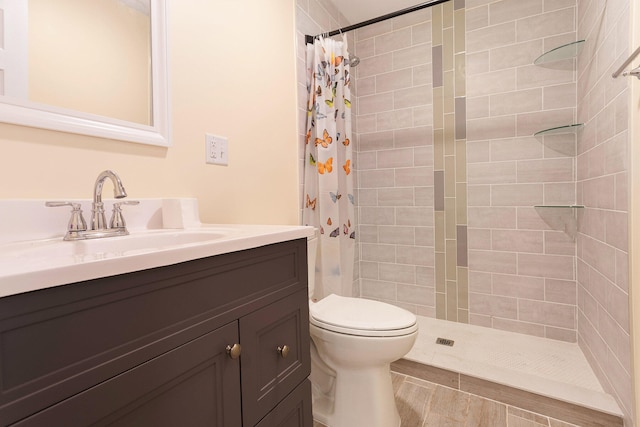 bathroom with vanity, a shower with shower curtain, and toilet