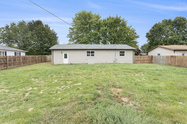 back of house with a yard