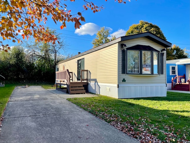 view of side of home with a yard