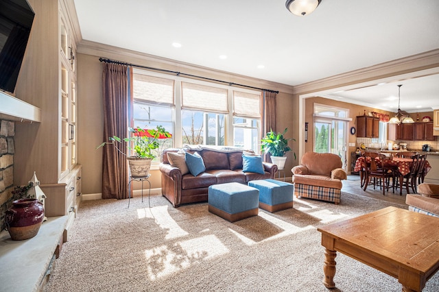 carpeted living room with crown molding and a chandelier