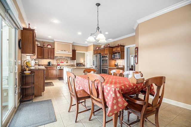 tiled dining space with a notable chandelier and ornamental molding