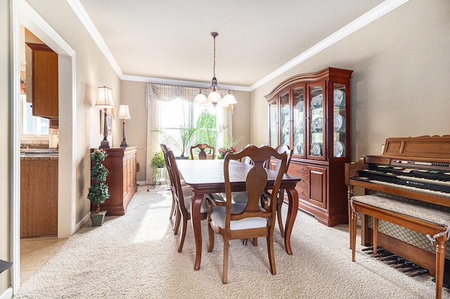 tiled dining area featuring crown molding and an inviting chandelier