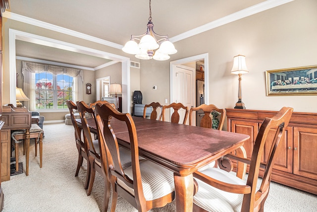 carpeted dining room with crown molding and a chandelier