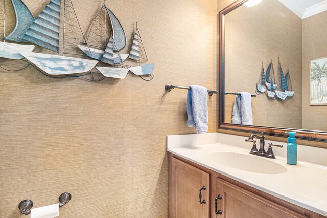 bathroom with vanity and ornamental molding