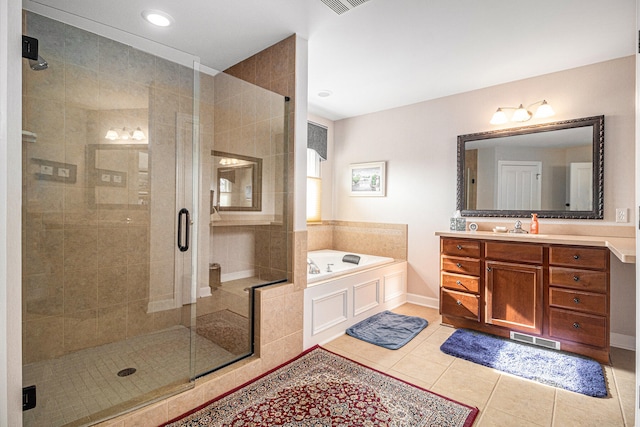 bathroom featuring vanity, shower with separate bathtub, and tile patterned flooring