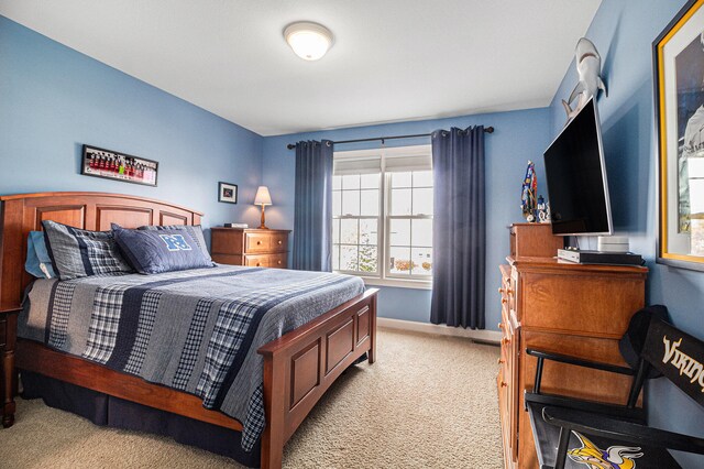 bedroom featuring light carpet