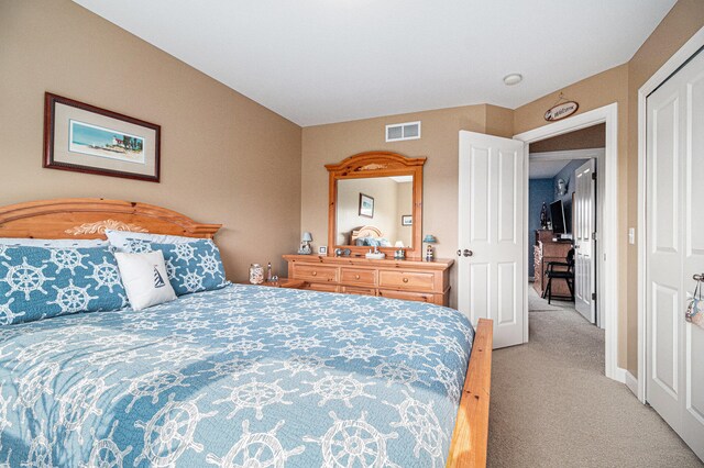 bedroom with a closet and light colored carpet