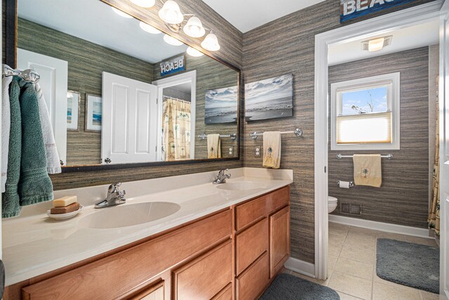 bathroom with vanity, toilet, and tile patterned floors