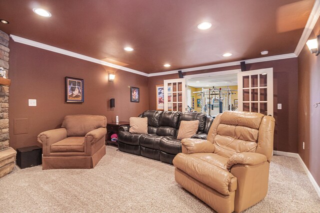 carpeted cinema with crown molding and french doors