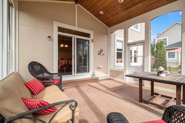 sunroom with lofted ceiling and wood ceiling