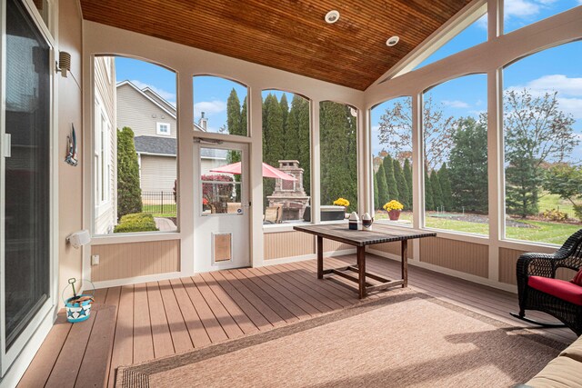 sunroom with wood ceiling and lofted ceiling