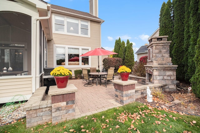 view of patio / terrace with an outdoor stone fireplace