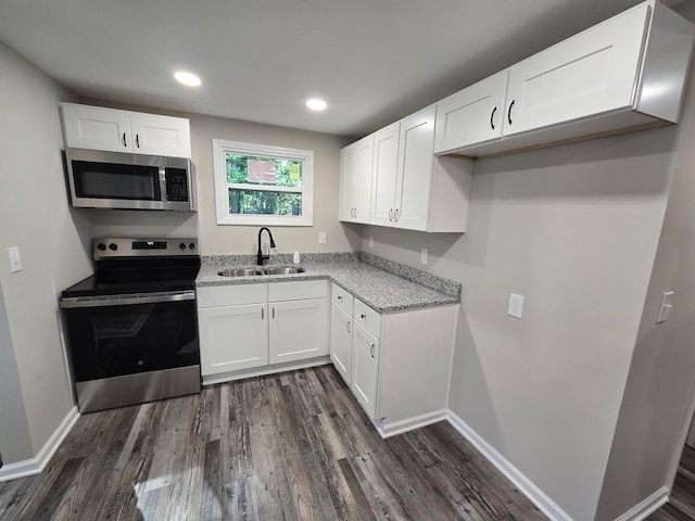 kitchen featuring sink, appliances with stainless steel finishes, white cabinets, and dark hardwood / wood-style flooring